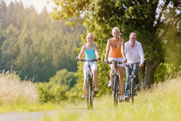 eine Familie macht eine Fahrrad-Toru durch die Natur